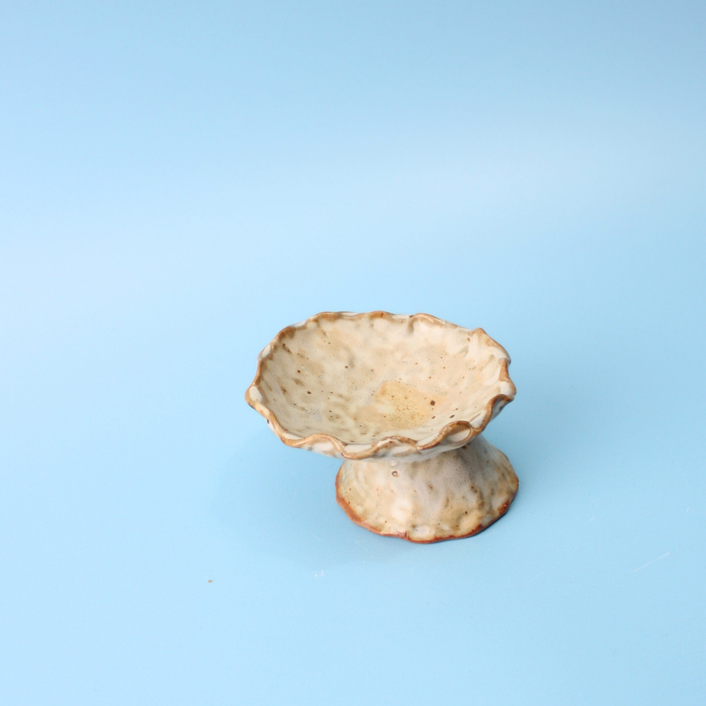 tan pedestal dish