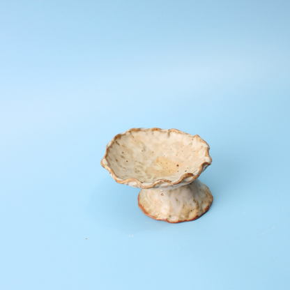 tan pedestal dish
