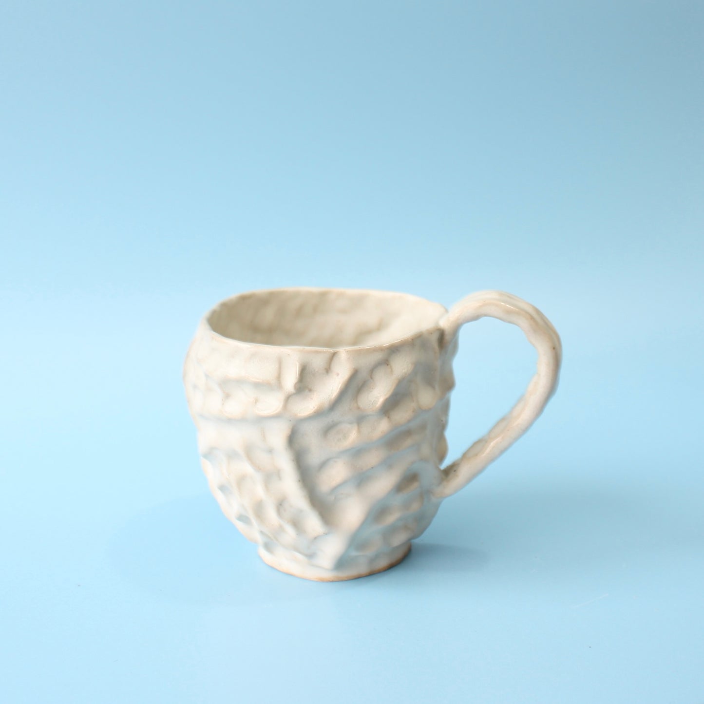white pinched mug