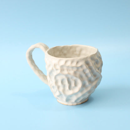 white pinched mug