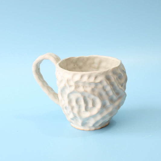 white pinched mug