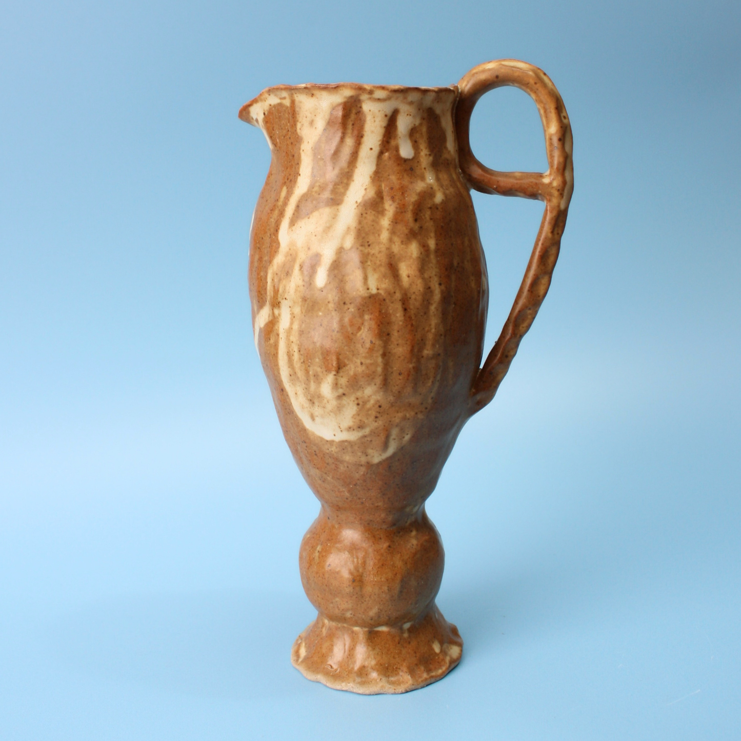 small brown pedestal pitcher