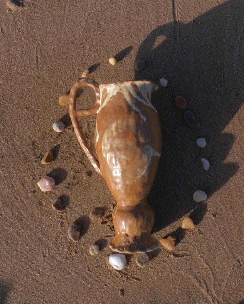 small brown pedestal pitcher